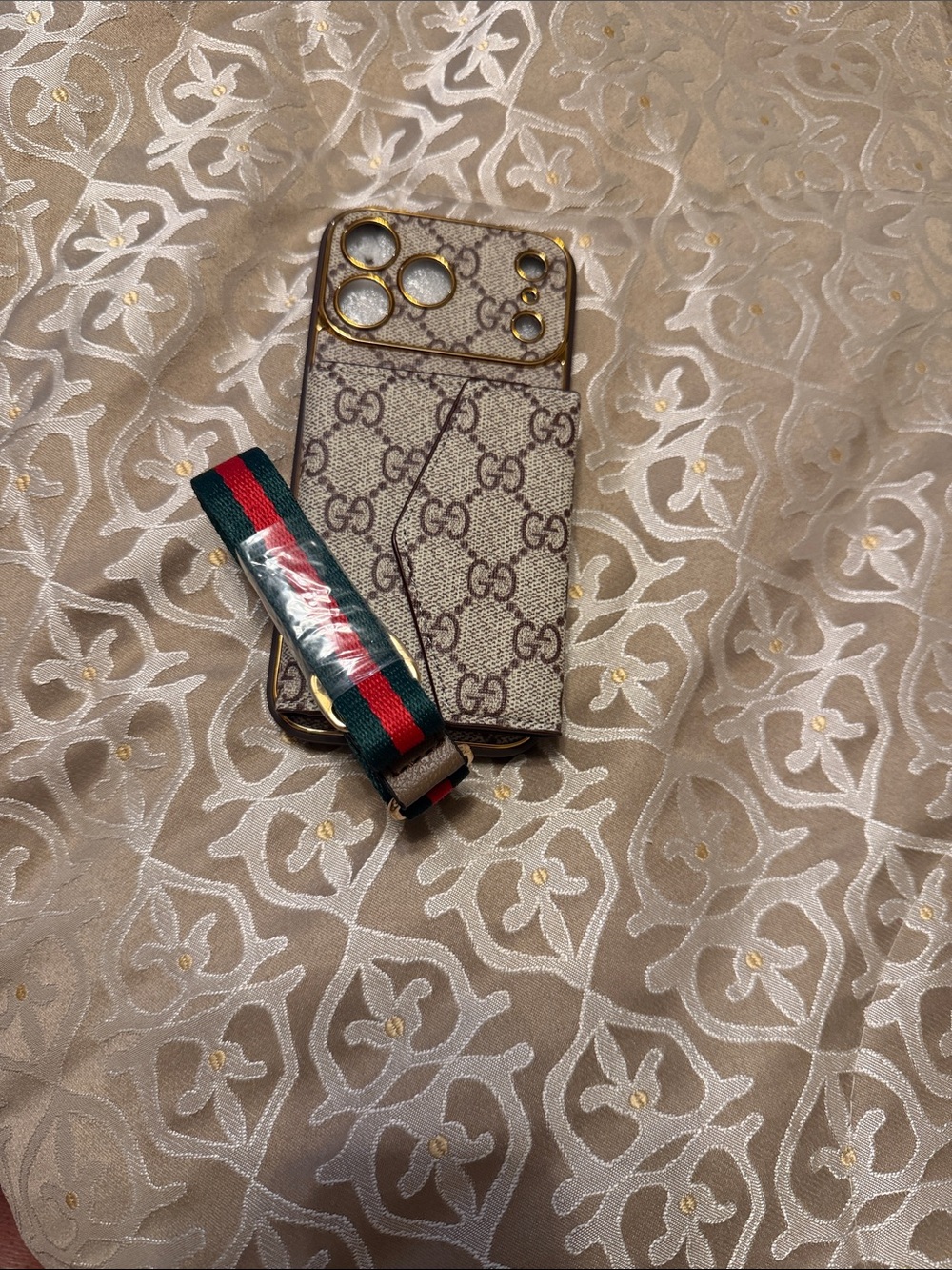 Beige Monogram Phone Case with Striped Wrist Strap IPhone 17 Pro Max.